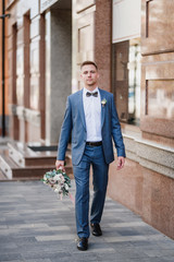 Fototapeta premium Photo shoot of the newlyweds on the street. Kirov Avenue. Saratov.