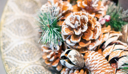 Natural Christmas New Year's toy pine cone and Christmas tree branch close-up. Winter Christmas New Year background.