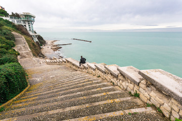 Stairway Passetto Ancona Marche Italy with man sitting on the stairway thinking and watching the...