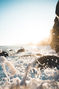 Beautiful Crystal Clear Blue Wave Splash Crashing Against Rock Cliff with Colorful Blue Sky in Scenic Background in Tranquil Tropical Island Paradise Nature Scene of Maui Hawaii
