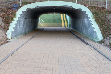 Underpass under a busy road. A place for pedestrians in the tunnel.
