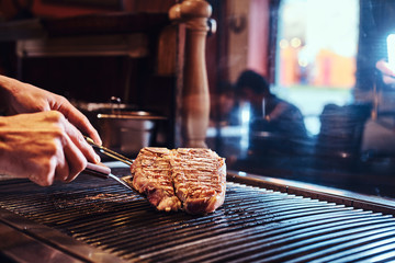 Close-up image of a cooking delicious meat steak on a grill