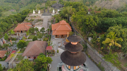 buddhist temple Brahma Vihara Arama with statues gods. aerial view balinese temple, old hindu...