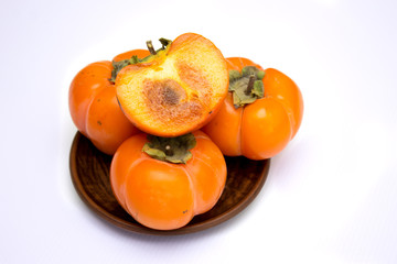 Fresh ripe persimmon, persimmon. Vitamins in the winter