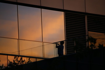 Silhouette of a Child at a Glass Building
