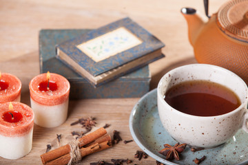 cup of tea with cookies and cinnamon sticks