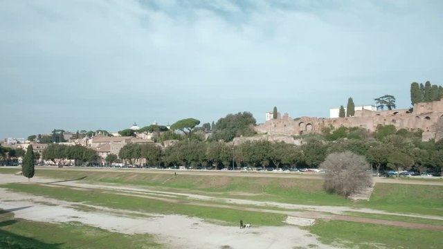 High angle panning right of Circus Maximus grounds with Palentine Hills ruins background in ancient Rome, Italy. 4K UHD at 29.97fps