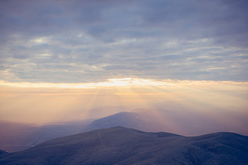 Sunset view from top of a mountain. View from Mount Nemrut, Turkey during golden hour. 