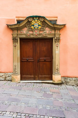 Fototapeta na wymiar Rustic old wooden double door with ornamental crests, Germany, Europe