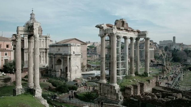 Panning left tilt up view of ancient Roman Forum or Foro Romano ruins seen from Capitoline Hill viewpoint in Rome, Italy. 4K UHD at 29.97fps