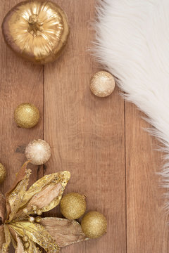 Christmas background. Gold Christmas balls on a wooden background. Winter holidays concept. Top view with copy space, vertical image