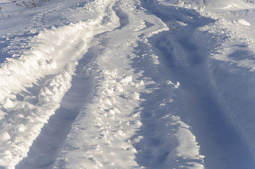 Fototapeta na wymiar Tire tracks in deep snow