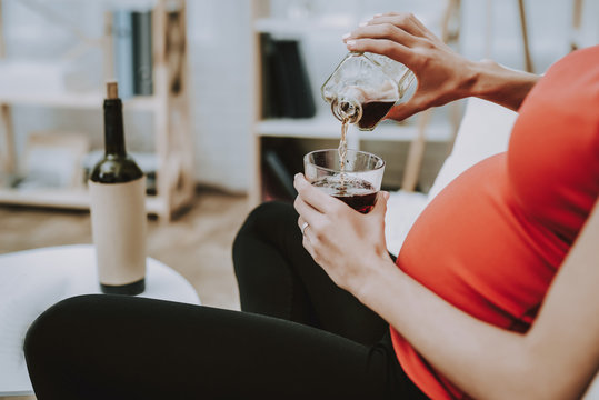 Pregnant Woman Drinks an Alcohol