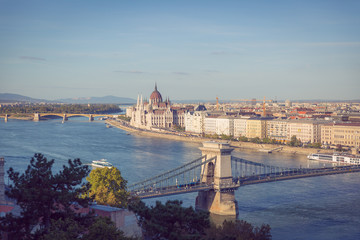 Fototapeta na wymiar A postcard view of the Széchenyi Chain Bridge and the Hungarian Parliament Building. View from the top of the Buda Castle. 