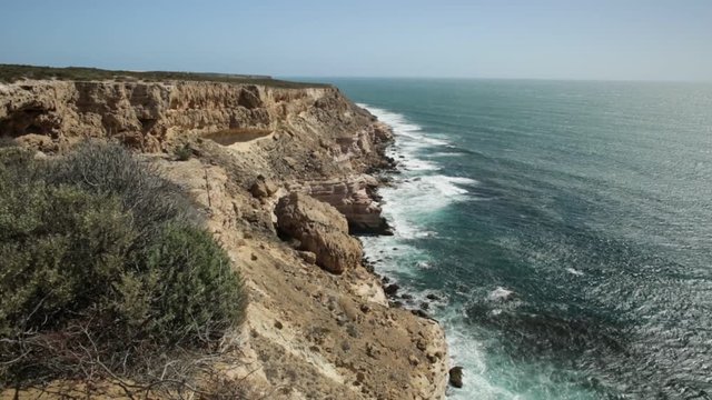 Island Rock, a natural limestone in Australian Coral Coast, Kalbarri National Park. Scenic panorama of turquoise Indian Ocean. Sunny with blue sky. Western Australia Outback.