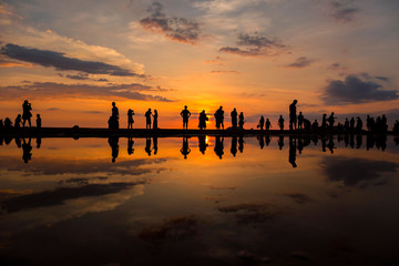 Silhouette of people visiting the Tanjung Aru beach during sunset located in Kota Kinabalu, Sabah, Malaysia.