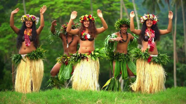 Young males and females in a group of Tahitian hula dancers performing outdoor barefoot in traditional costume Tahiti French Polynesia South Pacific
