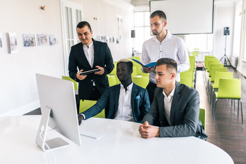 Young creative managers team working with new project in modern office. Business team. Coworking.