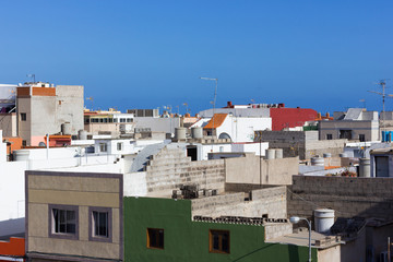 Fototapeta na wymiar Rooftops on sunny day in Vecindario town, Gran Canaria, Spain. Canary Islands building architecture, real estate concepts