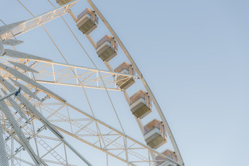 Fototapeta na wymiar Low angle view of a ferris wheel with blue sky background 