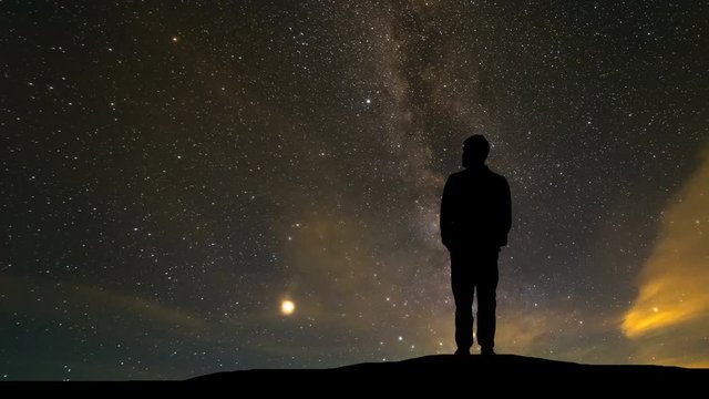 The man standing on the hill against the starry sky
