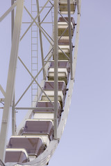 Low angle view of a ferris wheel with blue sky background 