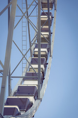 Low angle view of a ferris wheel with blue sky background 