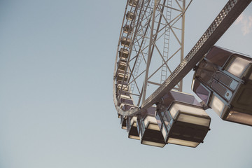 Low angle view of a ferris wheel with blue sky background 