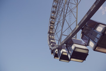 Low angle view of a ferris wheel with blue sky background 