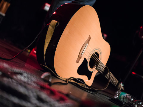 Close-up shot of an acoustic guitar on a stage