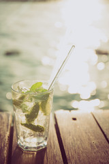 Cocktail at the wooden pier during sunset. Luxury vacation resort. Holiday getaway concept
