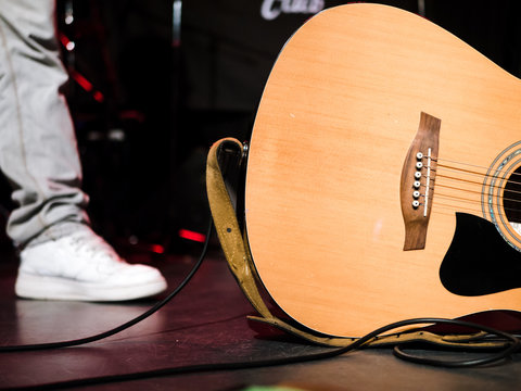 Close-up shot of an acoustic guitar on a stage