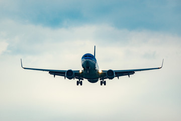 Landing of the passenger plane at sunset time