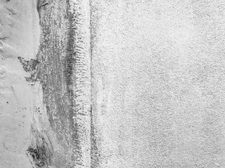 Weathered and dirty concrete wall texture background in black and white.