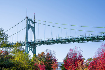 Part of the arched St Johns bridge in Portland in the colors of autumn trees