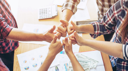 close up hand of business  people bump hands thumb up finishing up meeting showing unity , business...