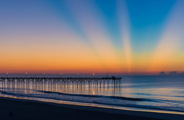 Fototapeta na wymiar Beams of light from the horizon during sunrise at Carolina Beach, North Carolina, USA