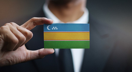 Businessman Holding Card of Karakalpakstan Flag