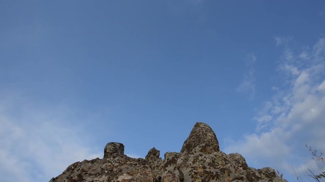 Camera pans down from the sky on the rocks of the Megalithic Observatory in Staro Nagorichane, Macedonia.