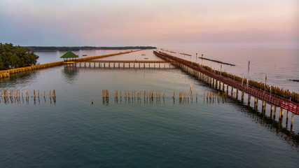Obraz premium Aerial view of red bridge in the sea