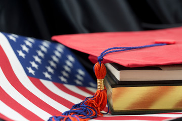 American education seen in books, flag, and graduation cap