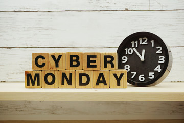 Cyber Monday sale shopping concept alphabet letter and alarm clock on wooden background