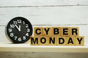 Cyber Monday sale shopping concept alphabet letter and alarm clock on wooden background