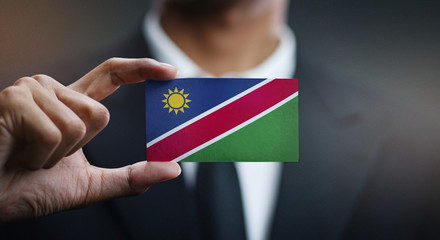 Businessman Holding Card of Namibia Flag