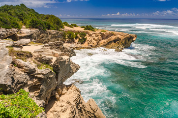 Fototapeta na wymiar Waves crashing on the coastal cliffs along the Mahaulepu Heritage Beach Trail in Kauai, Hawaii, USA