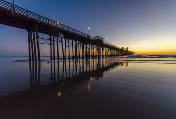 Fototapeta na wymiar pier with lights on at sunset in Oceanside, California, USA