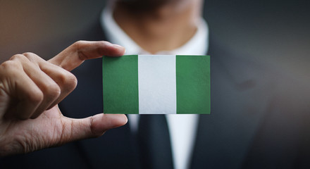 Businessman Holding Card Nigeria Flag