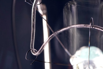 Tungsten filament in an incandescent lamp, macro photo.