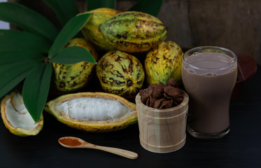 Fresh cacao fruit with cocoa crunch (Products Production from cacao) on table
