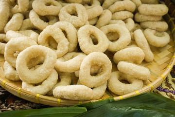 doughnut donut close up with plain taste with white color with banana leaf and bamboo plate